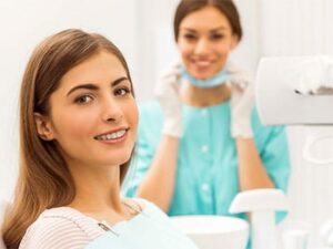 adult woman with braces smiling at doctor office