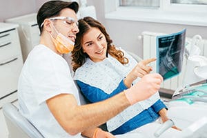 Dentist and patient looking at a dental x-ray.